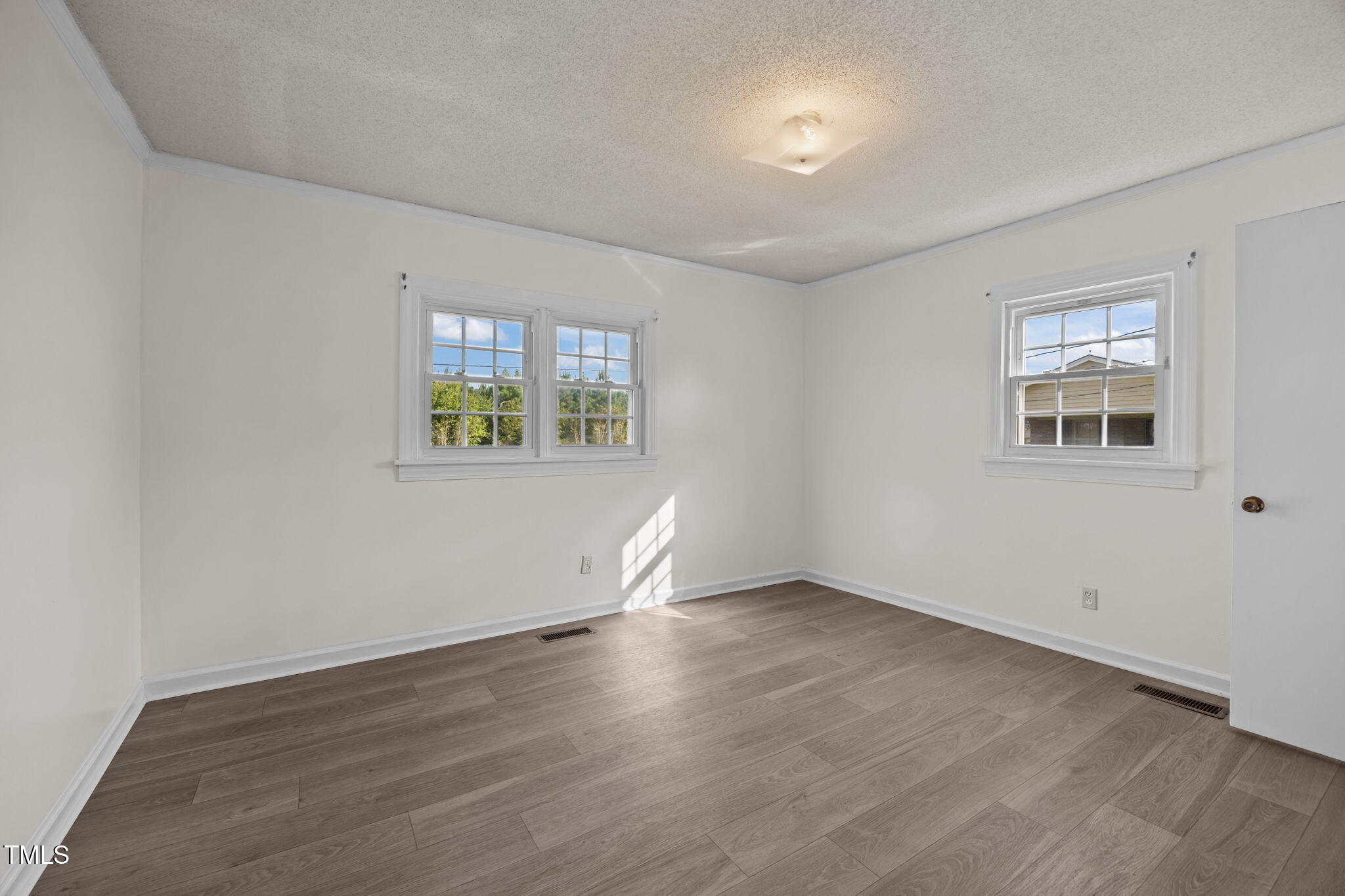 6590 Hassell Road Robersonville, NC 27871 - Photo 16 of 42 an empty room with wooden floor and windows