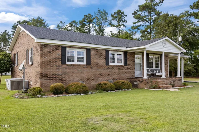 a front view of a house with a garden and porch