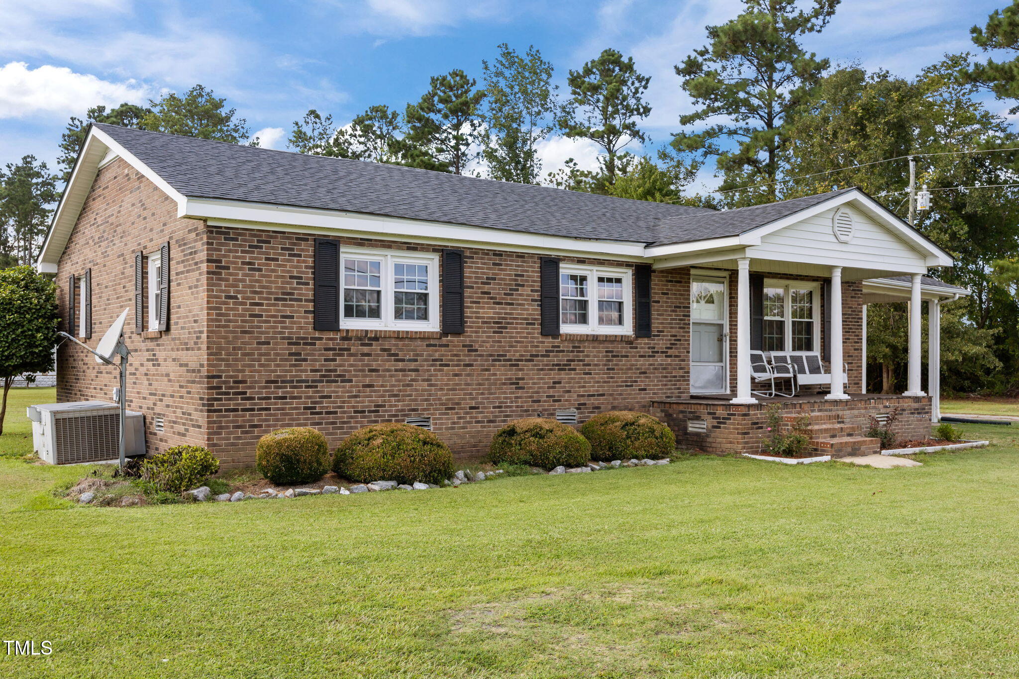 6590 Hassell Road Robersonville, NC 27871 - Photo 2 of 42 a front view of a house with a garden and porch