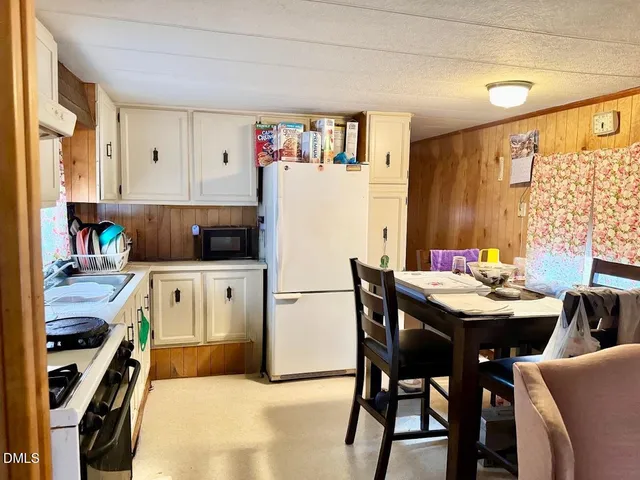 a kitchen with stainless steel appliances kitchen island granite countertop a table and chairs