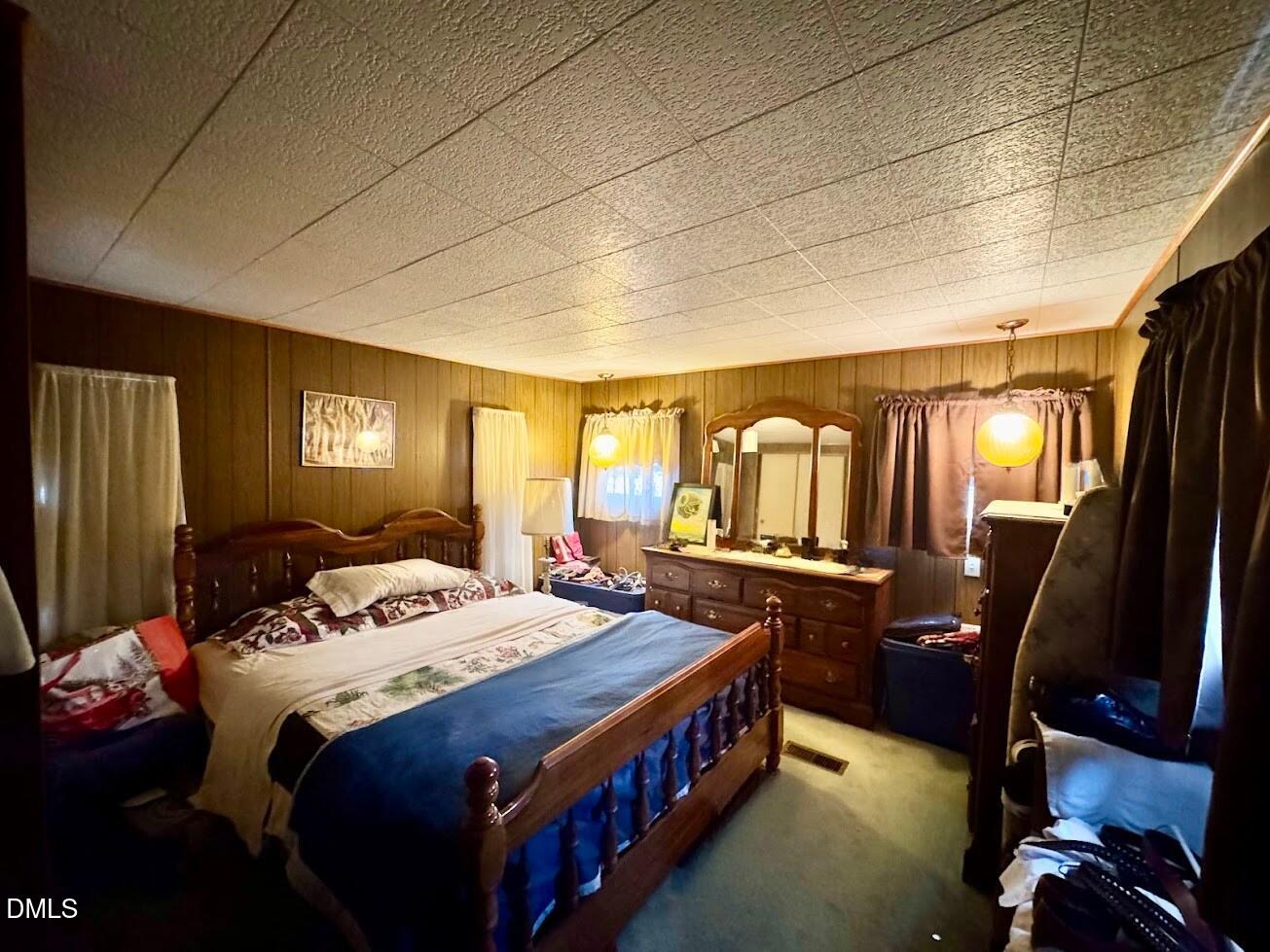 6590 Hassell Road Robersonville, NC 27871 - Photo 39 of 42 a bed room with a bed and dresser