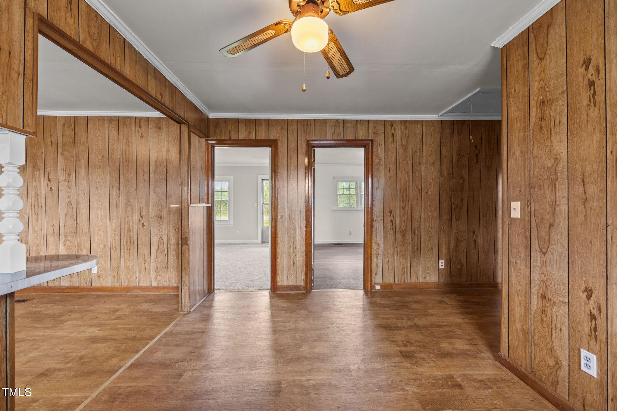 6590 Hassell Road Robersonville, NC 27871 - Photo 9 of 42 a view of a hallway with wooden floor and chandelier