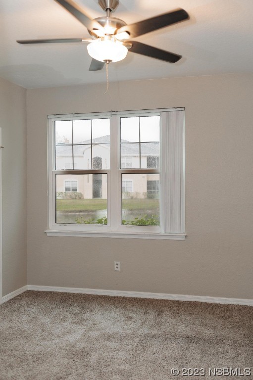 830 Airport Road, Unit 305 Port Orange, FL 32128 - Photo 12 of 27 an empty room with chandelier fan and windows