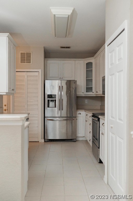 830 Airport Road, Unit 305 Port Orange, FL 32128 - Photo 7 of 27 a kitchen with a refrigerator a stove top oven and cabinets