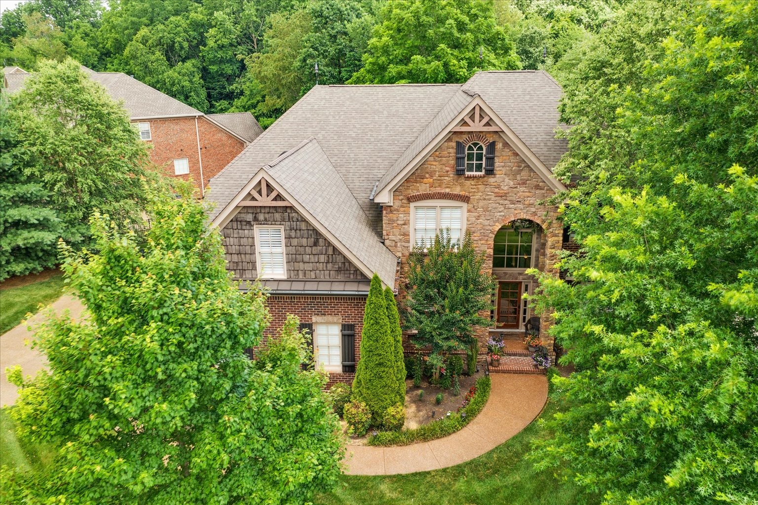 a aerial view of a house with a yard and potted plants