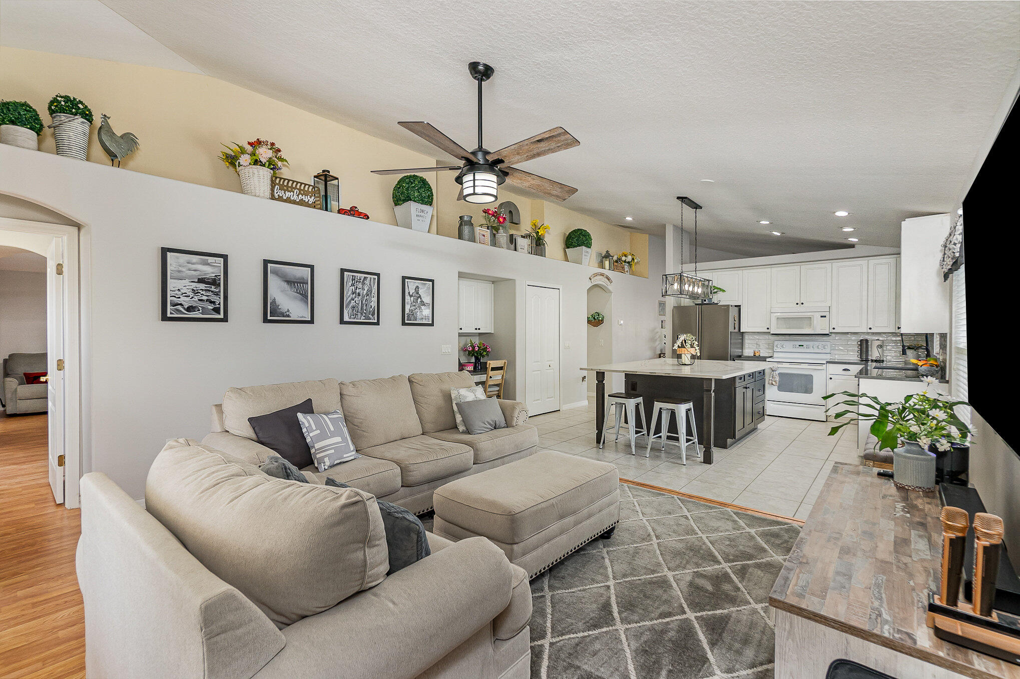 6914 Renshaw Drive Melbourne, FL 32940 - Photo 14 of 27 a living room with furniture kitchen view and a chandelier