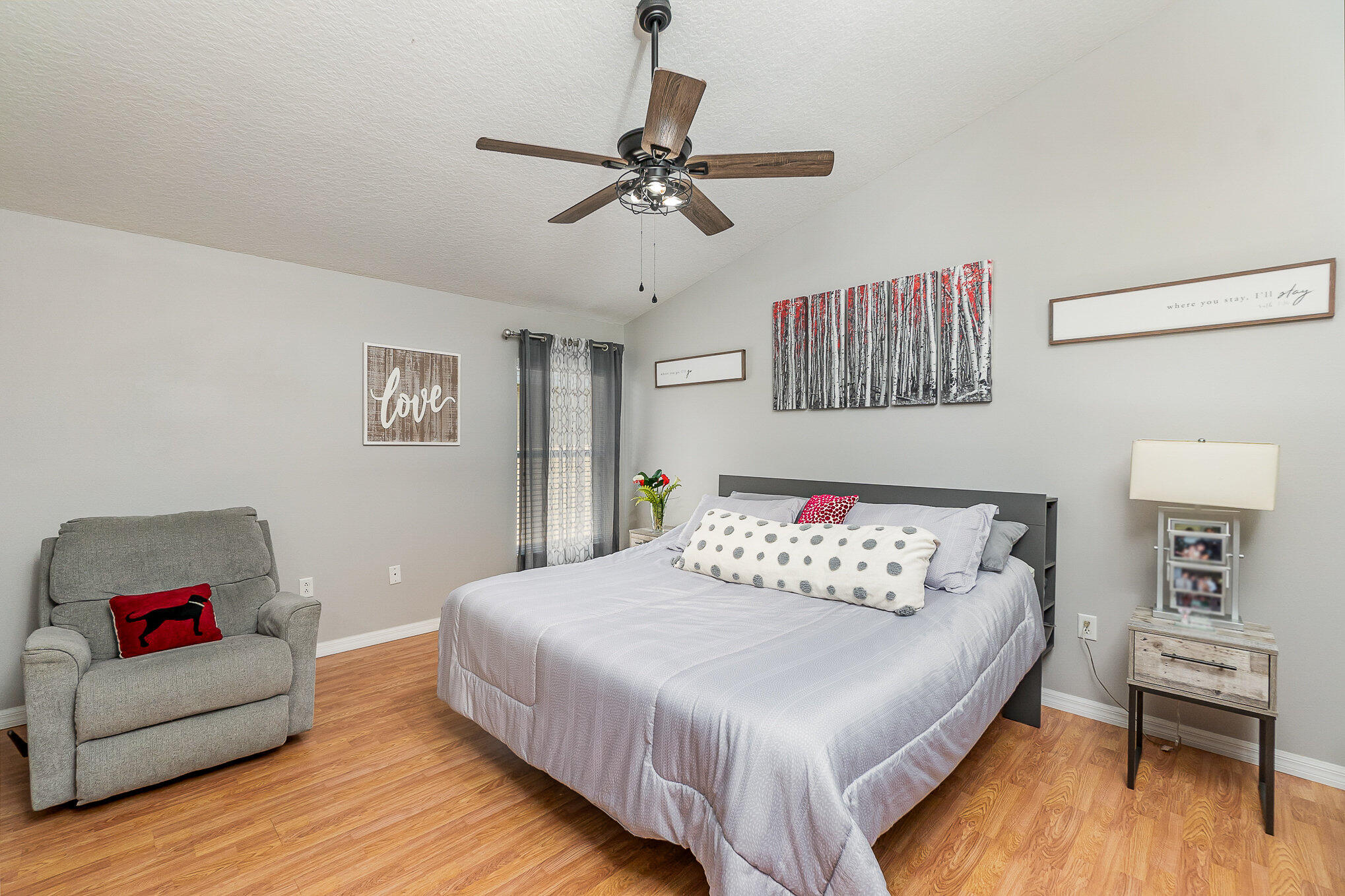 6914 Renshaw Drive Melbourne, FL 32940 - Photo 16 of 27 a bedroom with a bed and a couch