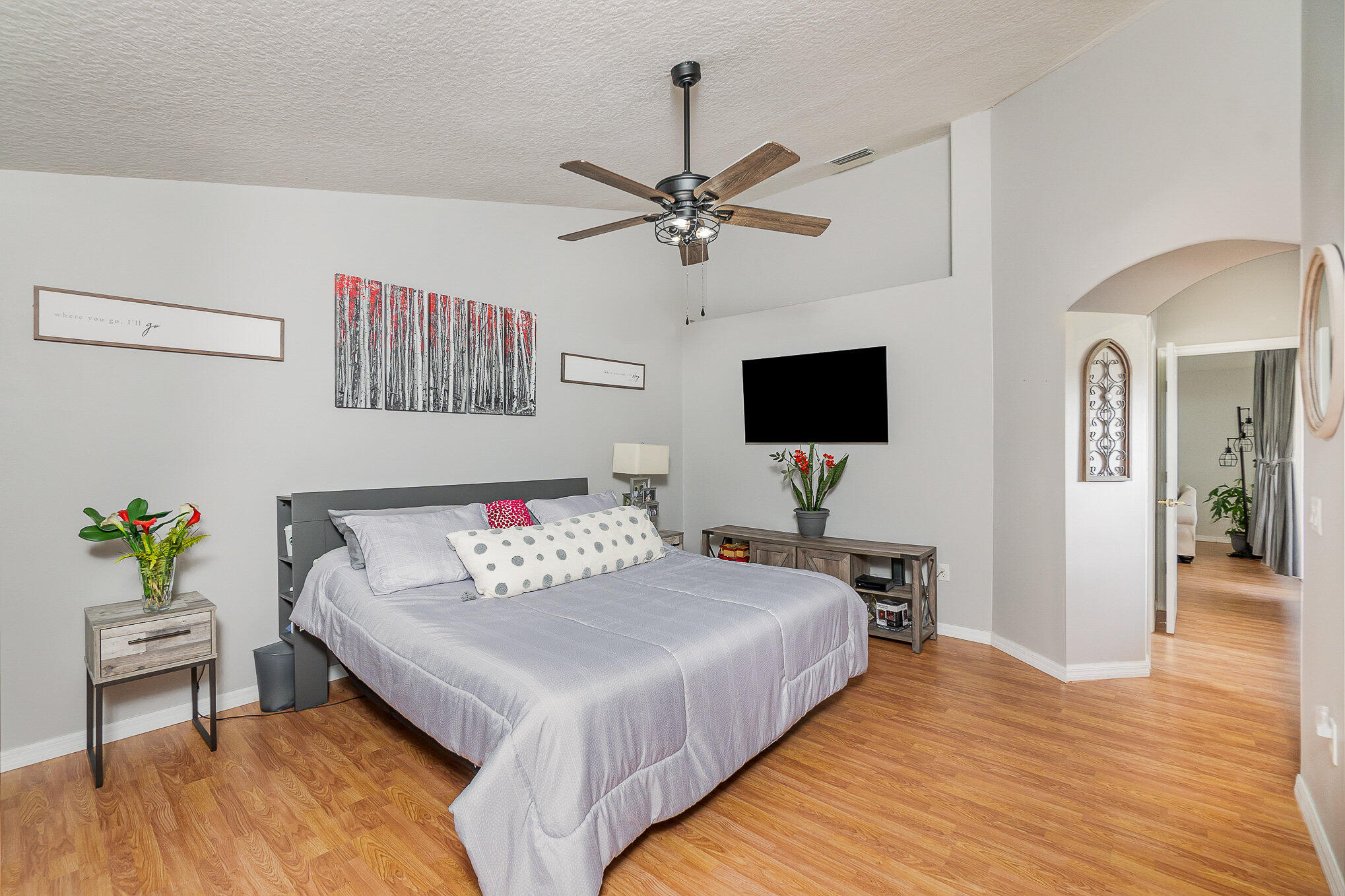 6914 Renshaw Drive Melbourne, FL 32940 - Photo 17 of 27 a bedroom with a bed and a flat screen tv