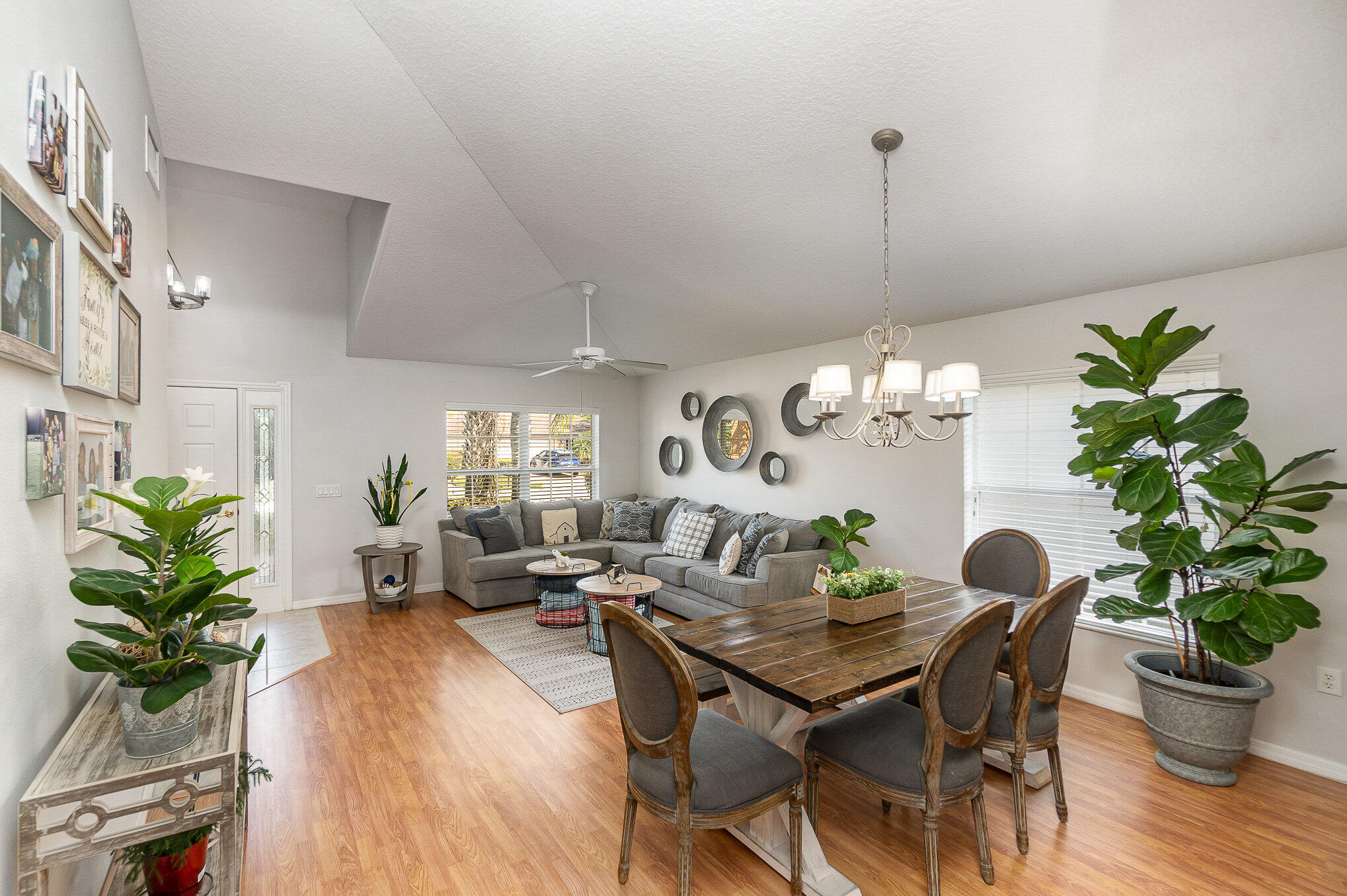 6914 Renshaw Drive Melbourne, FL 32940 - Photo 2 of 27 a dining room with furniture potted plants and wooden floor