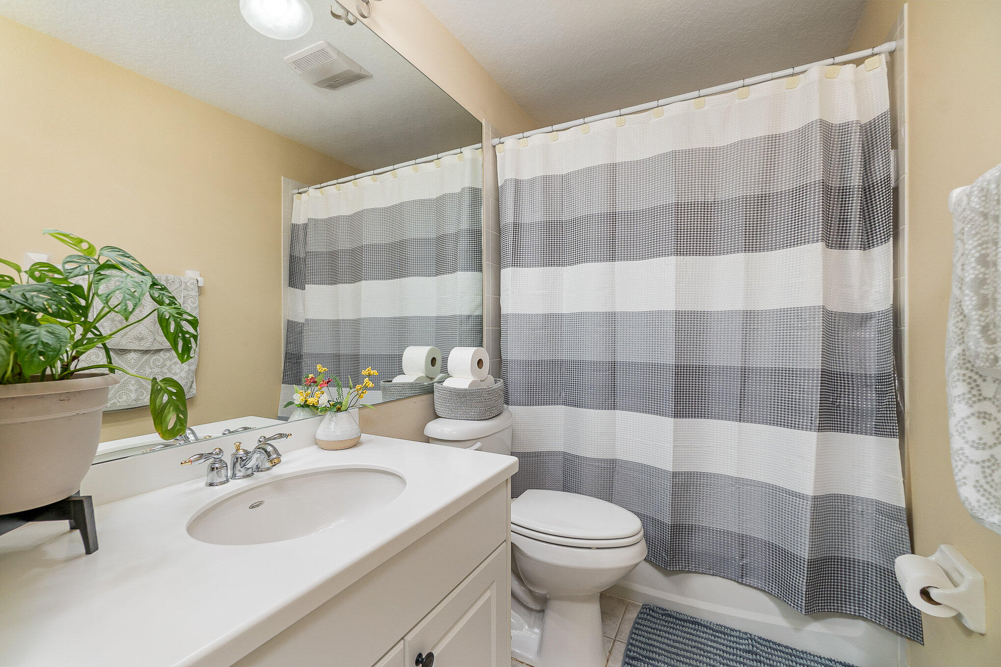 6914 Renshaw Drive Melbourne, FL 32940 - Photo 21 of 27 a bathroom with a sink a toilet and shower