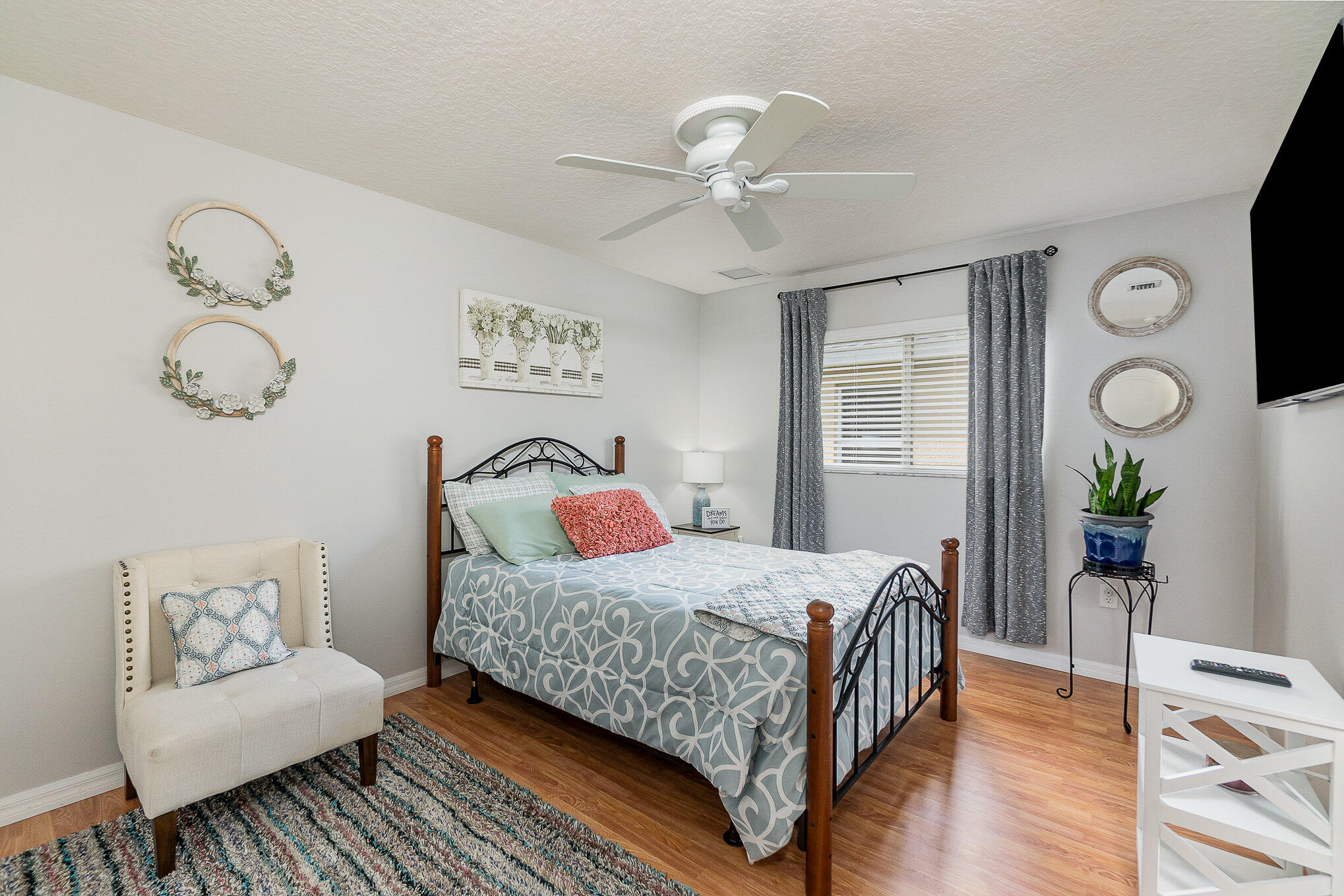 6914 Renshaw Drive Melbourne, FL 32940 - Photo 22 of 27 a bedroom with a bed and wooden floor