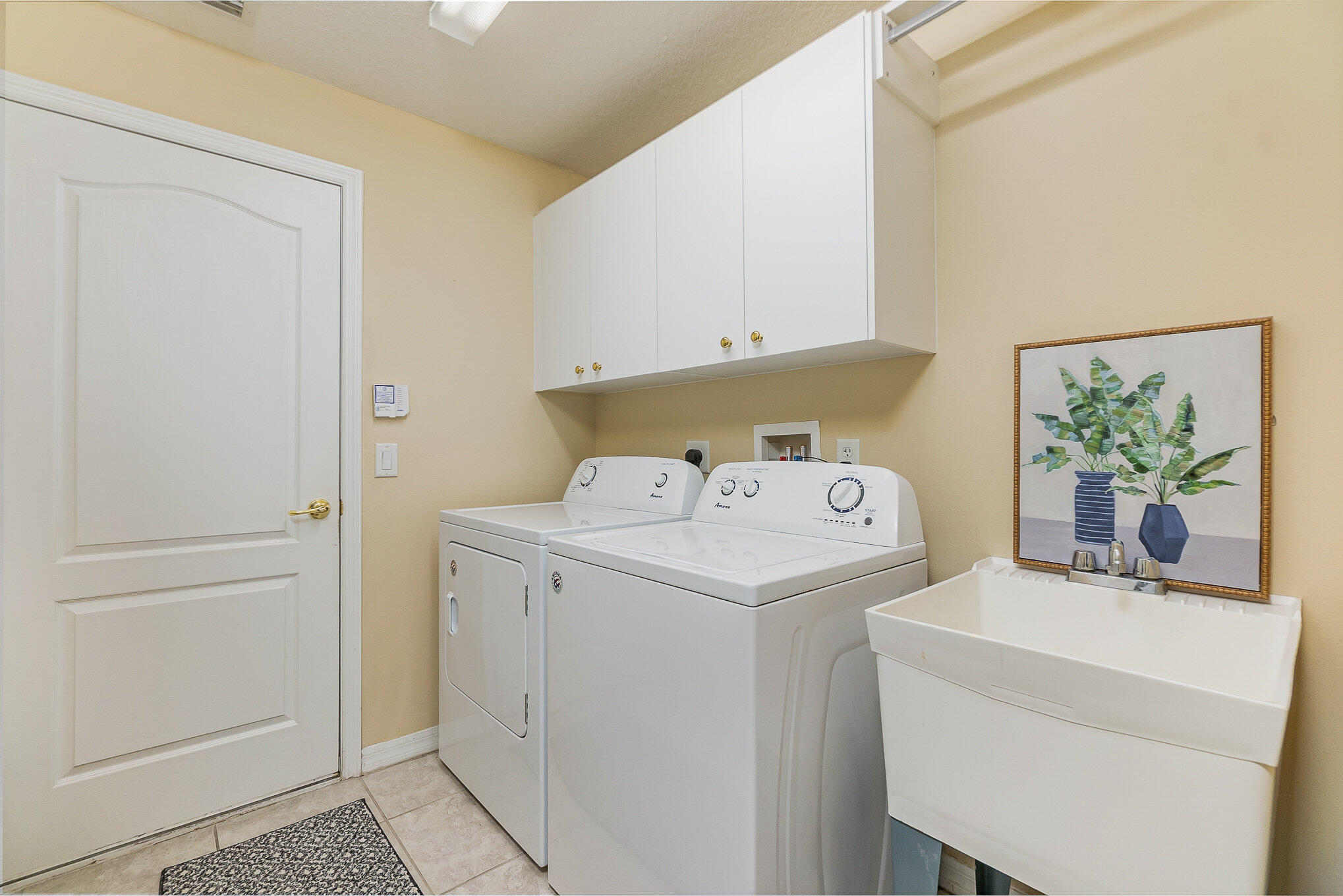 6914 Renshaw Drive Melbourne, FL 32940 - Photo 23 of 27 a utility room with dryer and washer