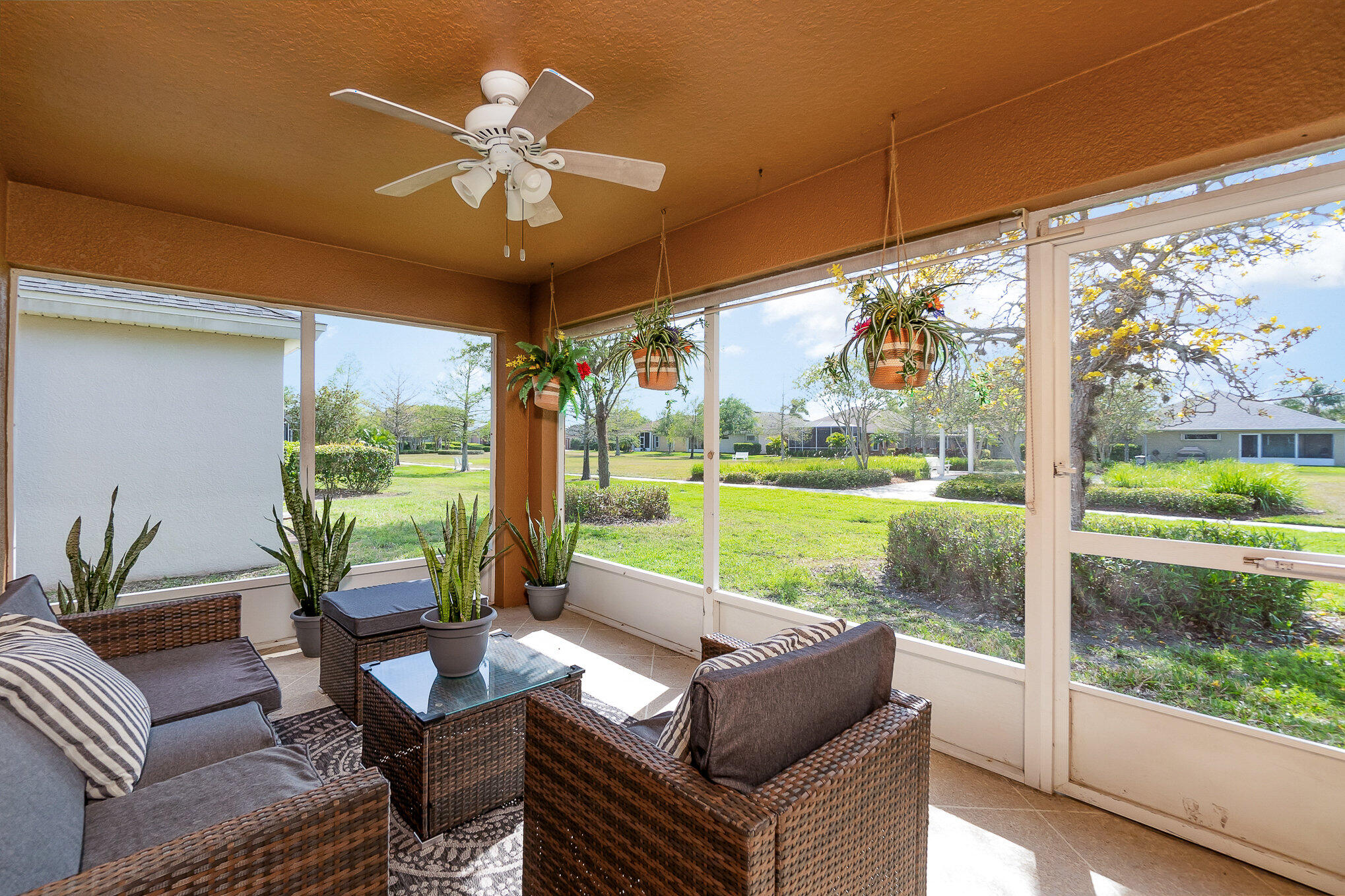 6914 Renshaw Drive Melbourne, FL 32940 - Photo 24 of 27 a living room with patio furniture and a floor to ceiling window