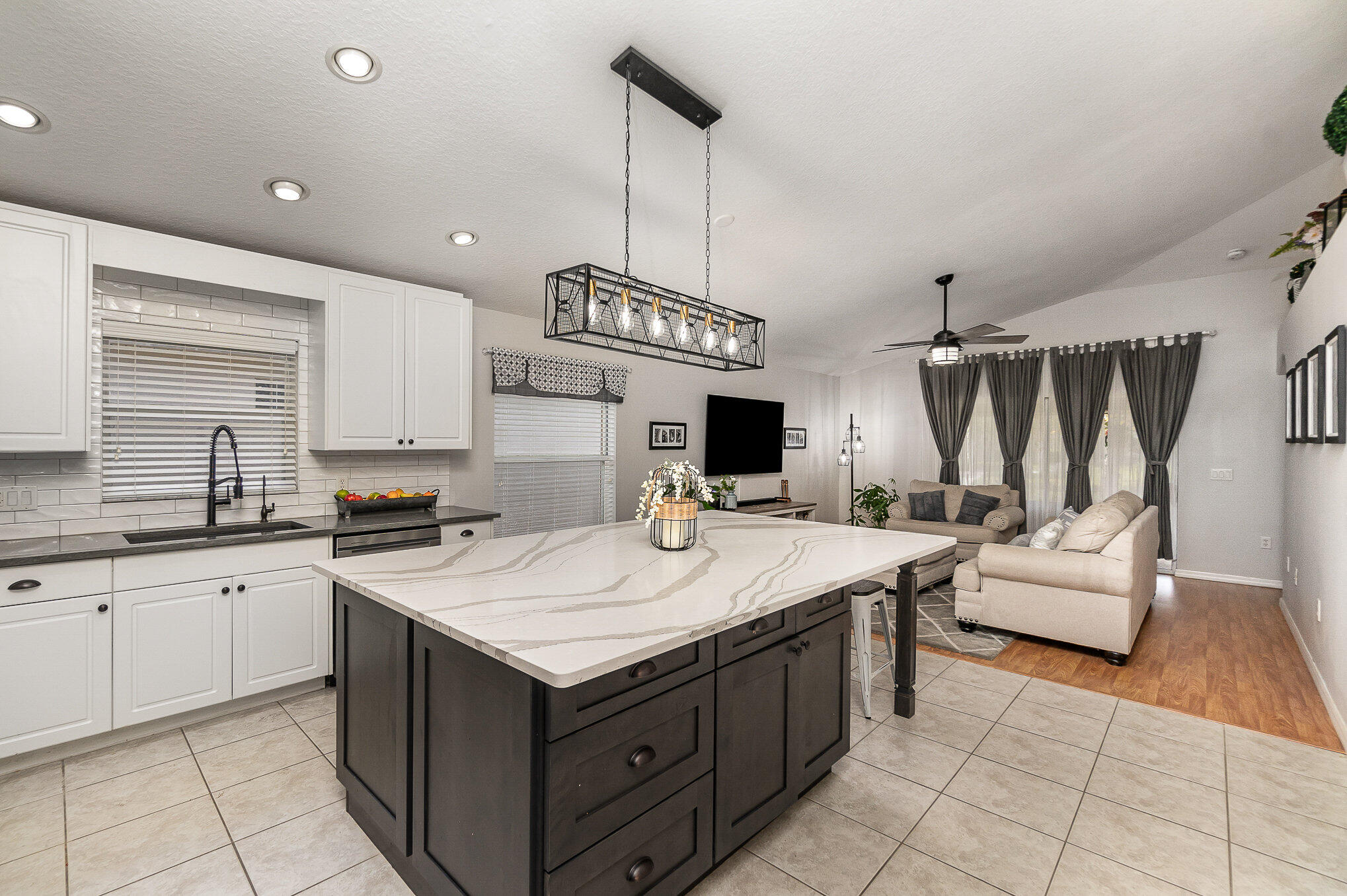 6914 Renshaw Drive Melbourne, FL 32940 - Photo 6 of 27 a kitchen with a sink and cabinets