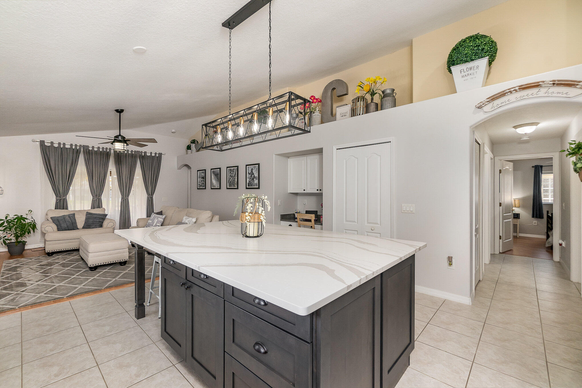 6914 Renshaw Drive Melbourne, FL 32940 - Photo 10 of 27 a kitchen with a sink a stove and chairs