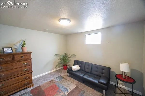 a living room with furniture and a lamp