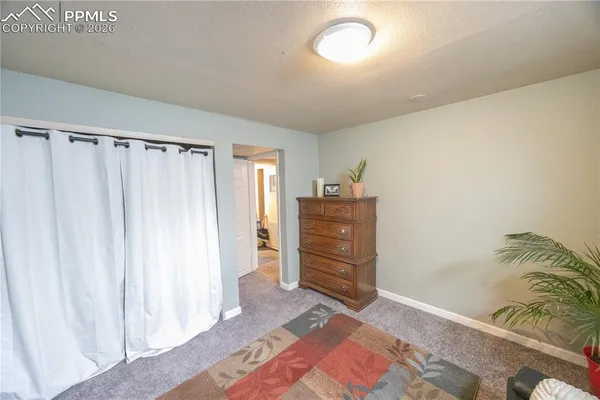 a room with a bed and curtain
