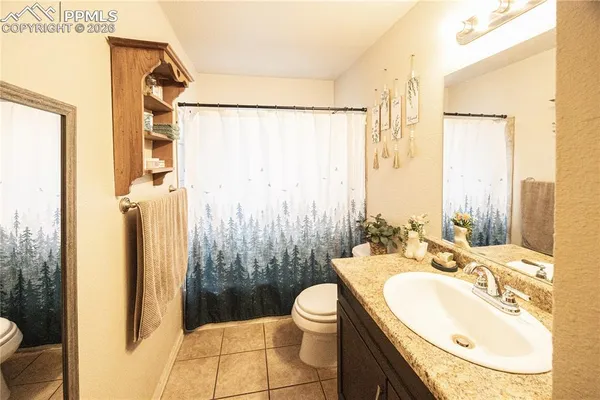 a bathroom with a double vanity sink toilet and shower