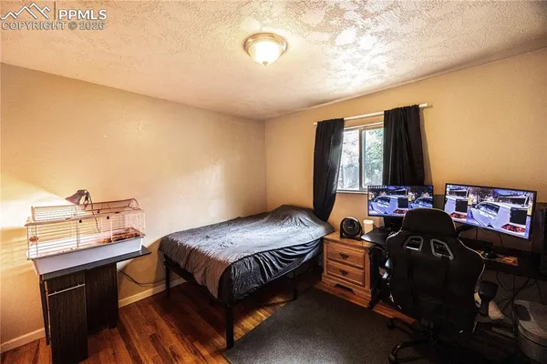a bedroom with a bed and dresser with mirror