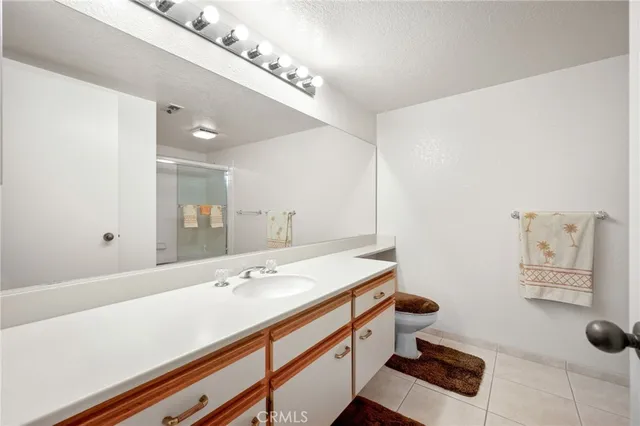 a bathroom with a sink a mirror and a toilet