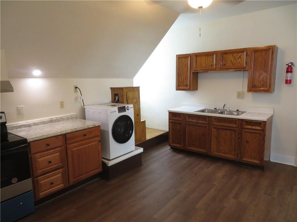 203 Main Street, Unit 3A Lyndora, PA 16045 - Photo 3 of 7 a kitchen with a sink and a stove top oven