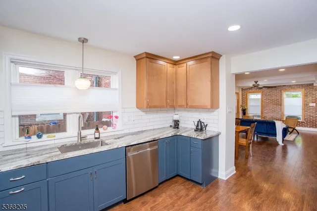a kitchen with stainless steel appliances a refrigerator a stove and a sink