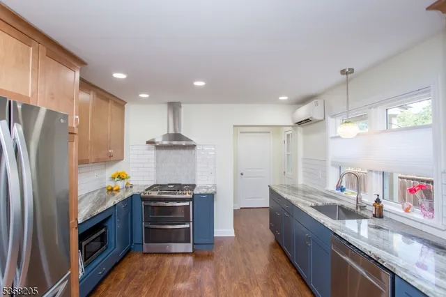 a kitchen with stainless steel appliances a stove a refrigerator and cabinets
