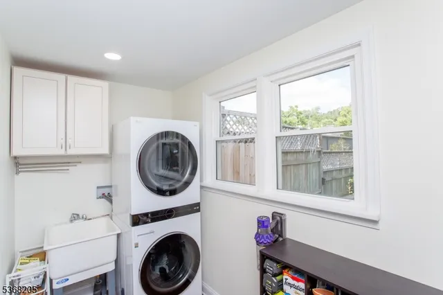 a bedroom with a bed and a dresser next to a window
