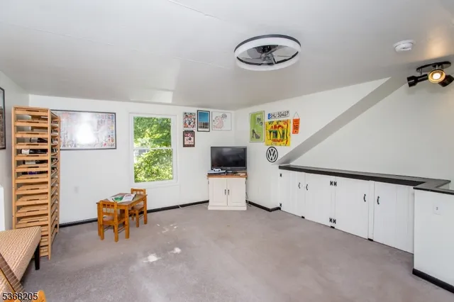 a view of a livingroom with furniture and a window
