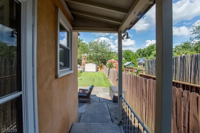 a backyard of a house with table and chairs