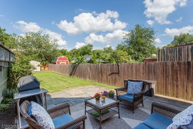 a white house that has tree in front of it