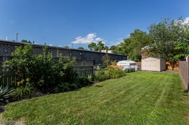 a view of a house with a yard and balcony