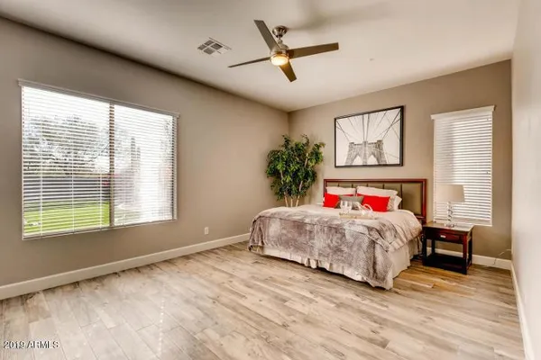 a bedroom with a large bed and a window