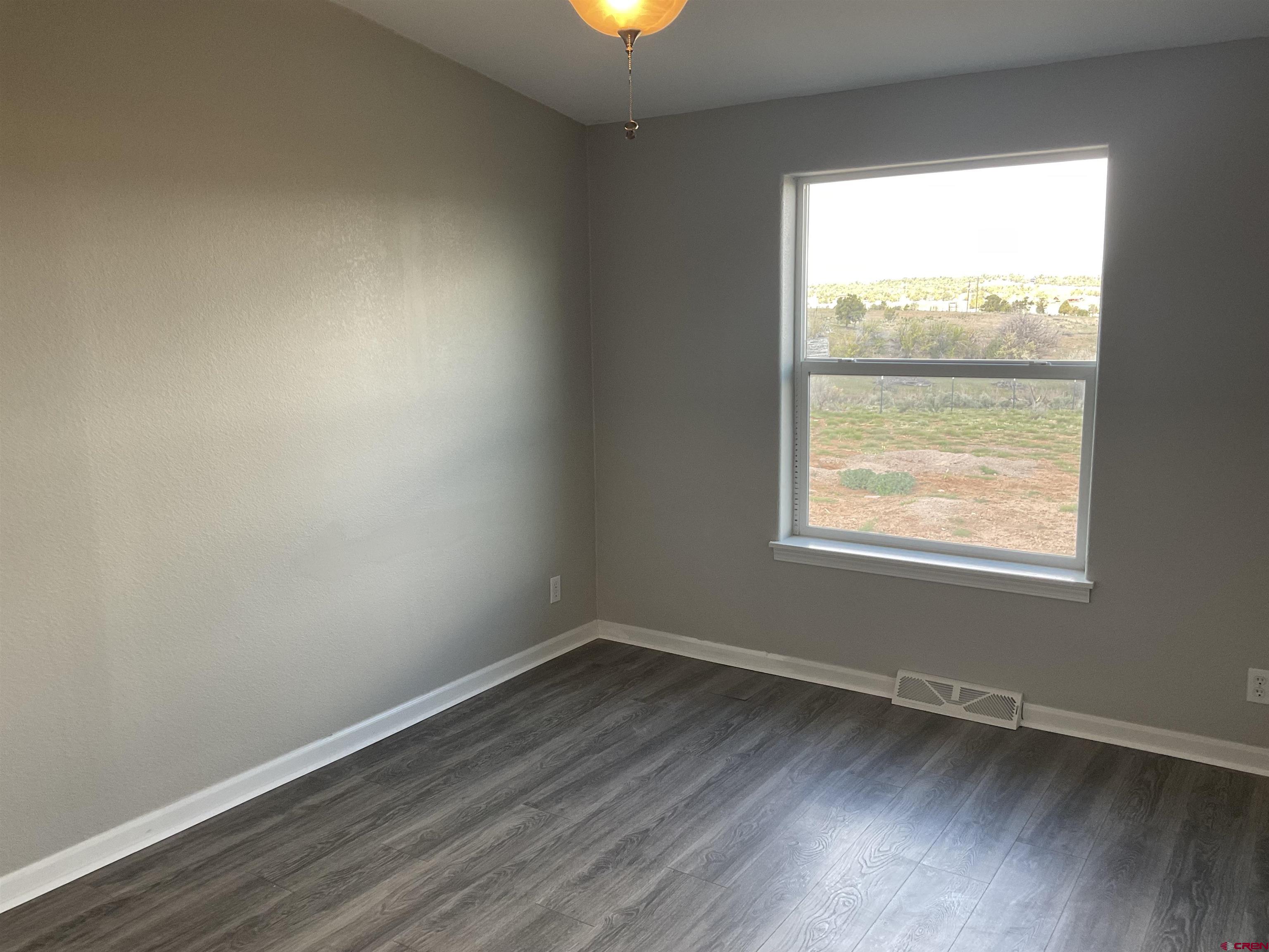 428 County Road 314 Ignacio, CO 81137 - Photo 14 of 24 an empty room with wooden floor and windows