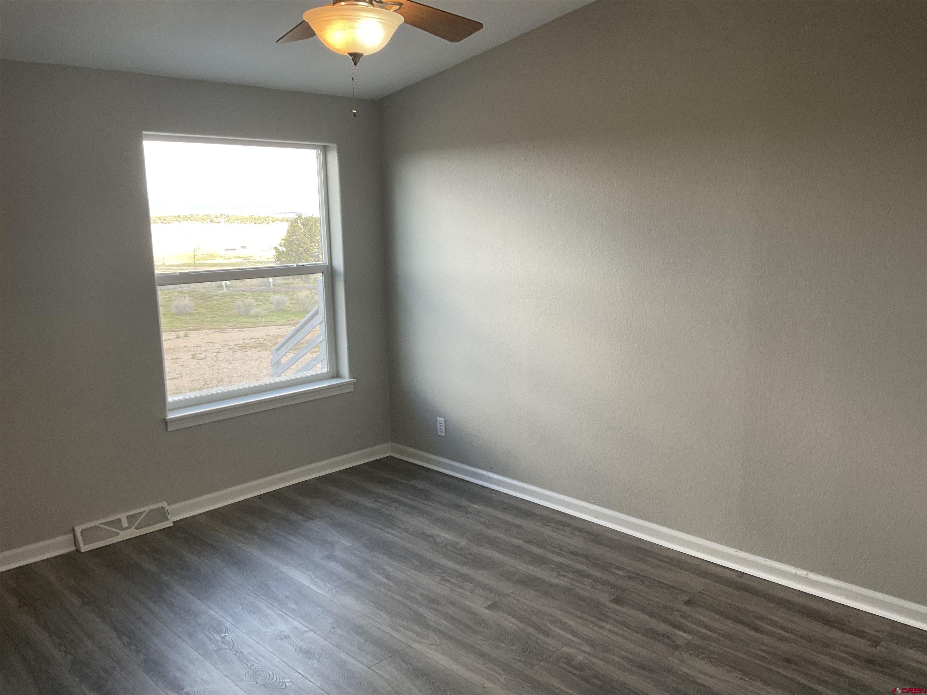 428 County Road 314 Ignacio, CO 81137 - Photo 15 of 24 a view of an empty room with wooden floor and a window
