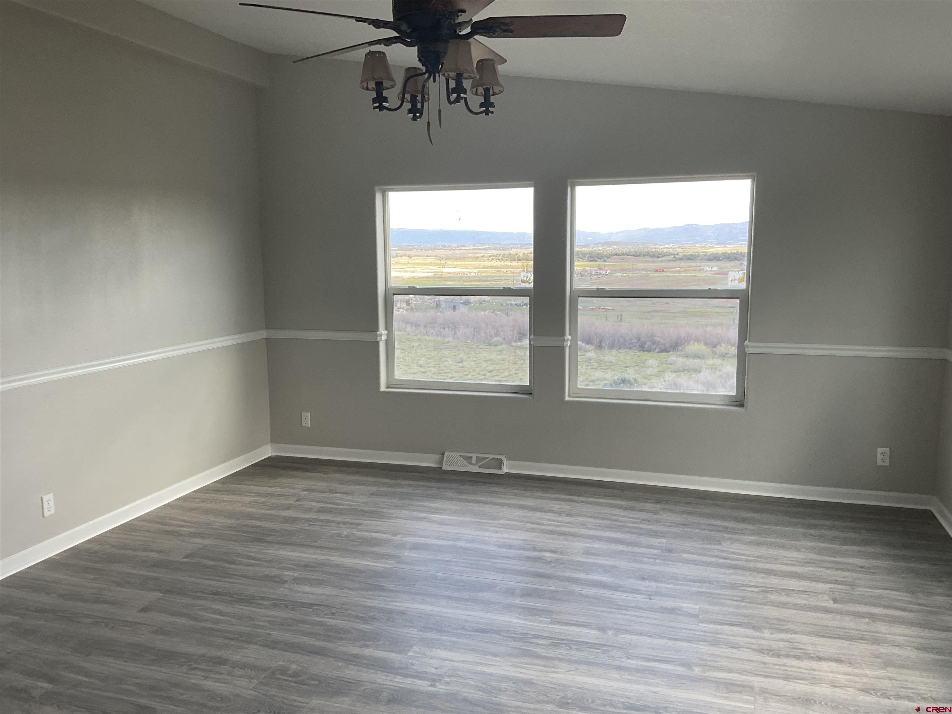 428 County Road 314 Ignacio, CO 81137 - Photo 16 of 24 an empty room with wooden floor and windows