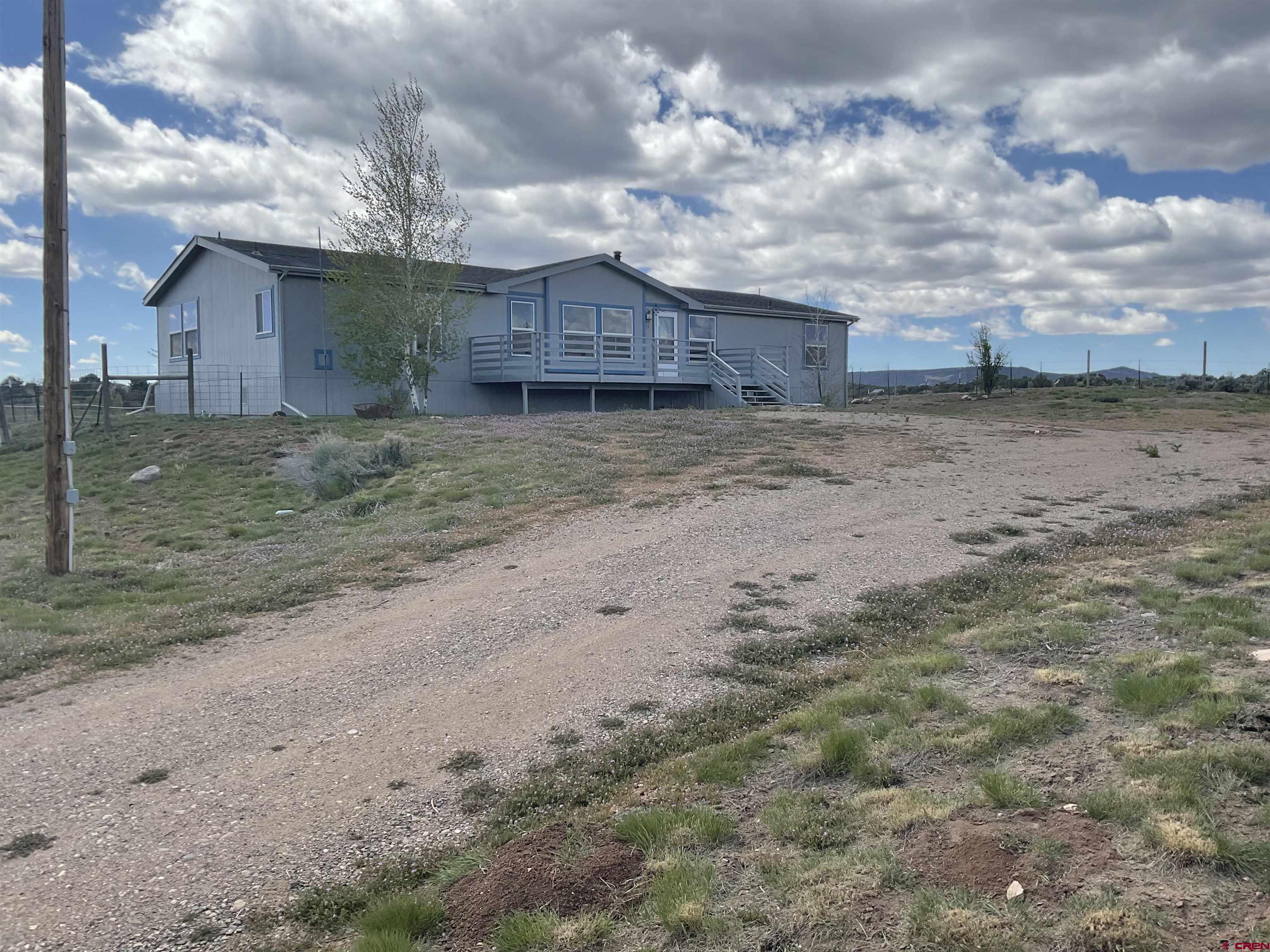 428 County Road 314 Ignacio, CO 81137 - Photo 2 of 24 a view of a house with a dry yard and a large tree