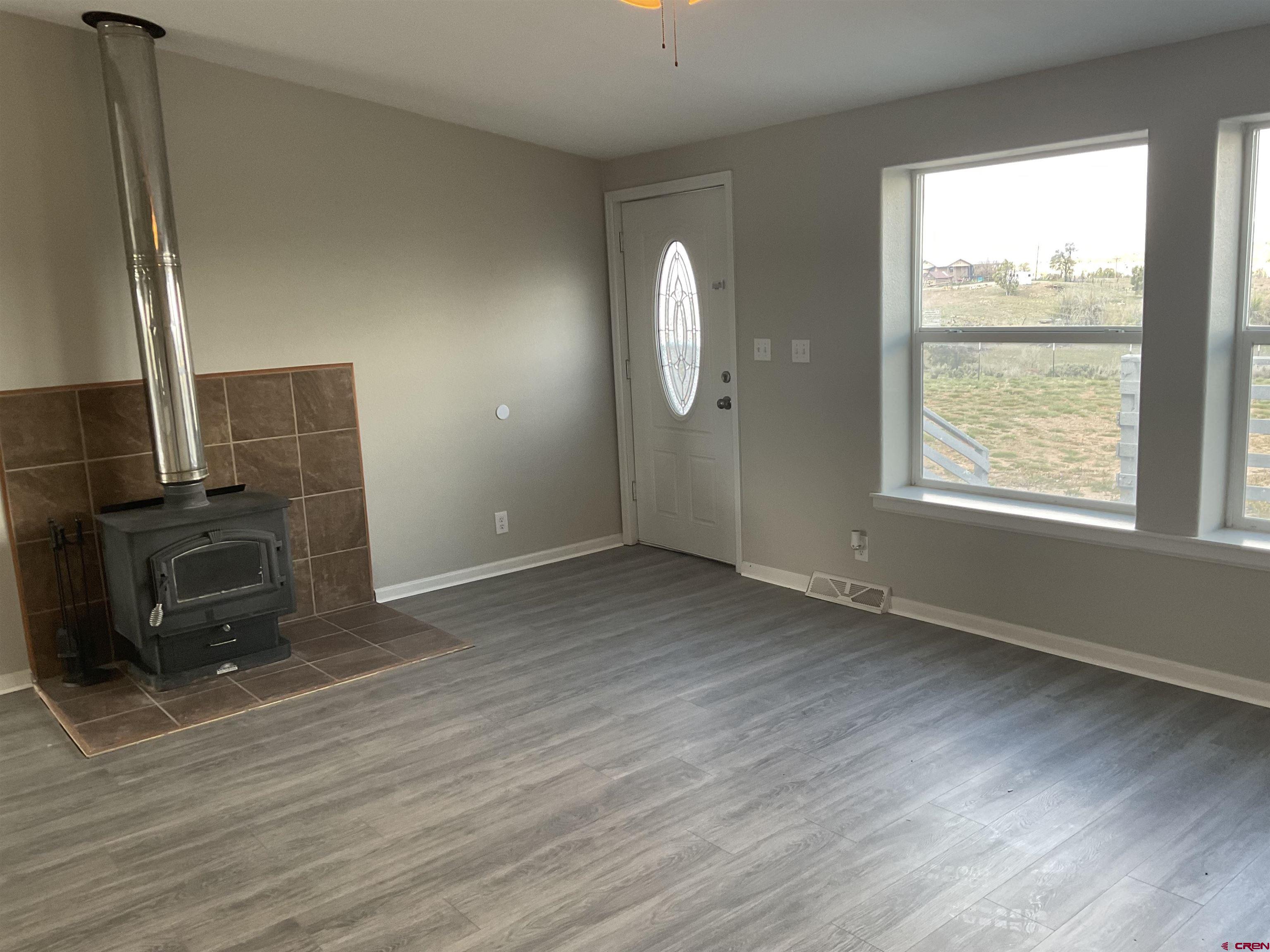 428 County Road 314 Ignacio, CO 81137 - Photo 7 of 24 a view of an empty room with wooden floor and a window