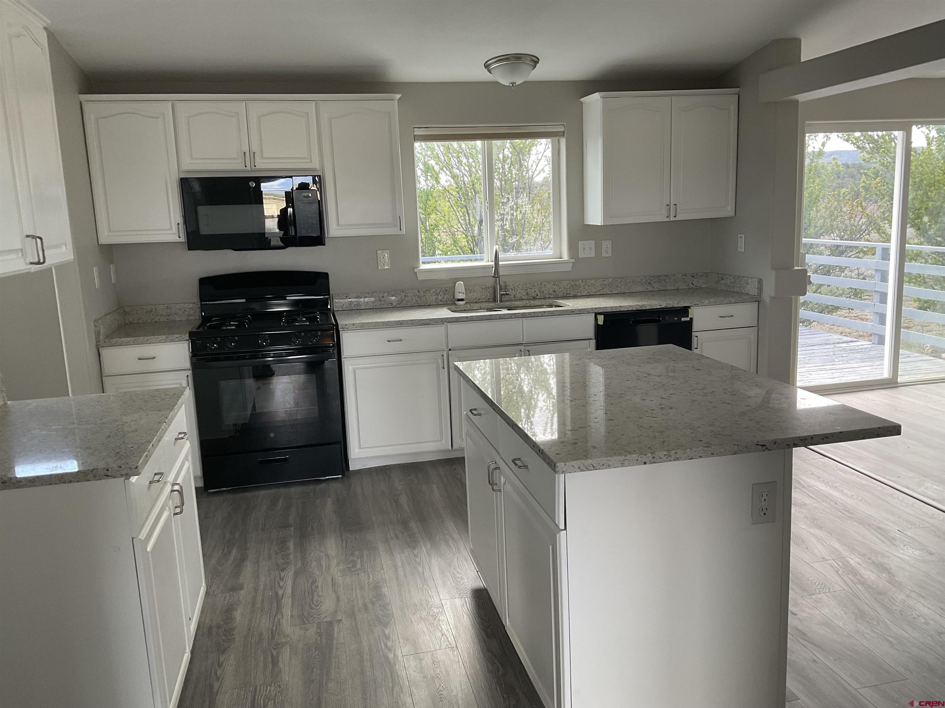428 County Road 314 Ignacio, CO 81137 - Photo 8 of 24 a kitchen with a sink a microwave a stove and refrigerator