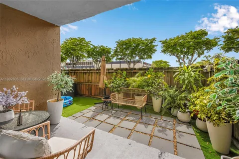 a view of a chairs and table in a patio