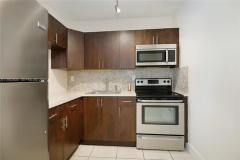 a kitchen with a stove and a microwave