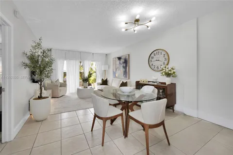 a view of a dining room with furniture and a chandelier fan