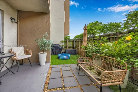 a view of a chair and tables in the patio
