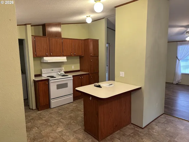 a kitchen with a sink a stove a refrigerator and a refrigerator