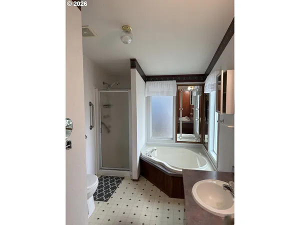 a bathroom with a tub toilet and sink