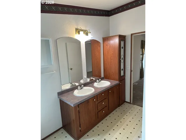 a bathroom with a double vanity sink and a mirror