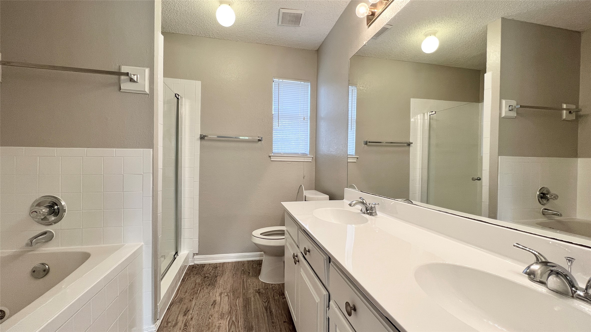 9201 Simmons Road, Unit 117 Austin, TX 78759 - Photo 15 of 20 A well-appointed bathroom features a double vanity and sleek fixtures, perfect for daily routines.