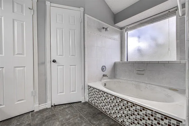a bathroom with a bathtub and shower