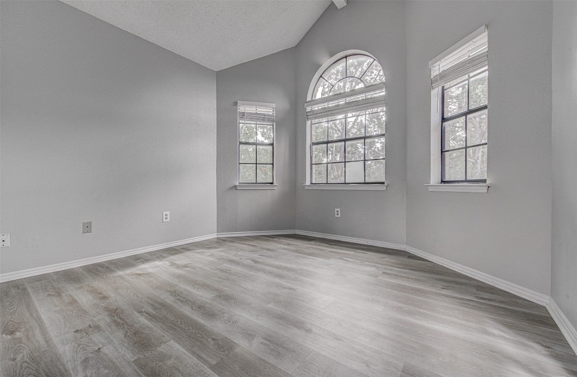 1401 Deepwoods Trail Leander, TX 78641 - Photo 20 of 34 an empty room with wooden floor and windows