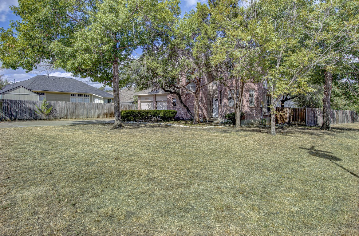 1401 Deepwoods Trail Leander, TX 78641 - Photo 2 of 34 a backyard of a house with lots of green space and fountain